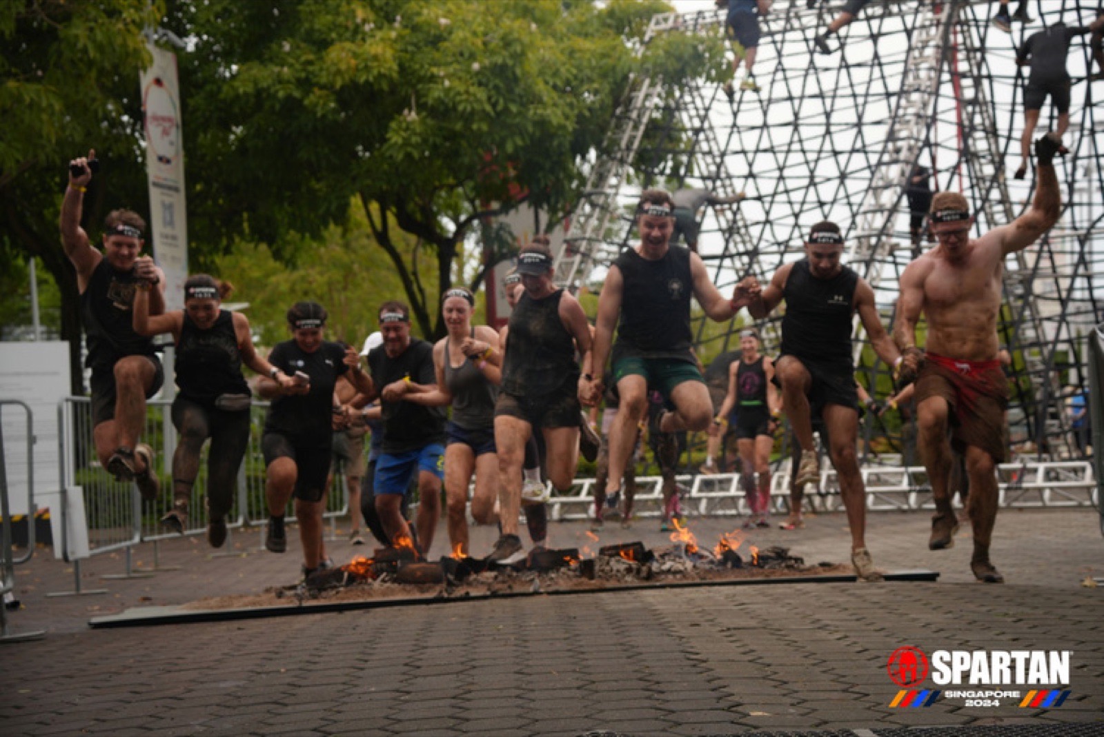 A FitBeat team covered in mud after a Spartan Race